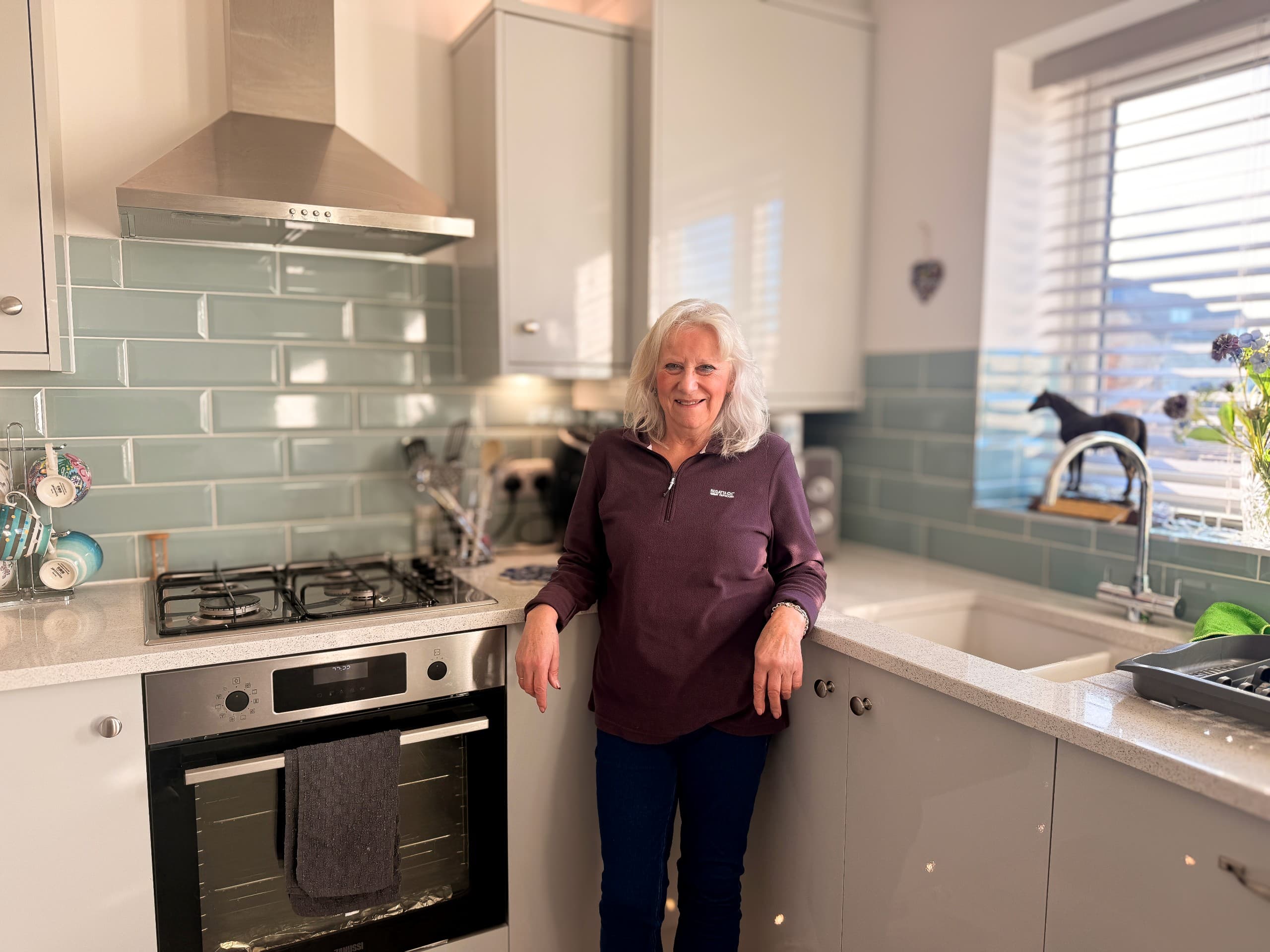 Jan case study image stood in kitchen of the lark