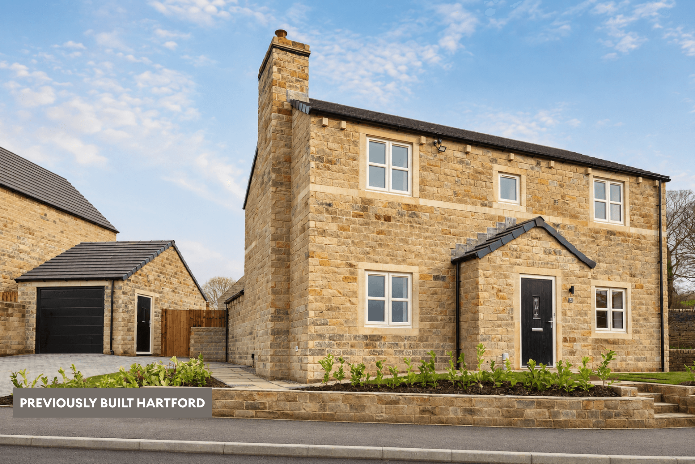 Previously built Hartford home in natural stone, with a black front door, detached garage, landscaped frontage and stone boundary wall.